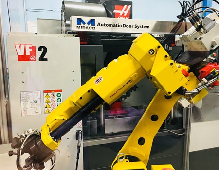 Midaco AutoDoor Opener on Haas Turning Center with robot machine tending