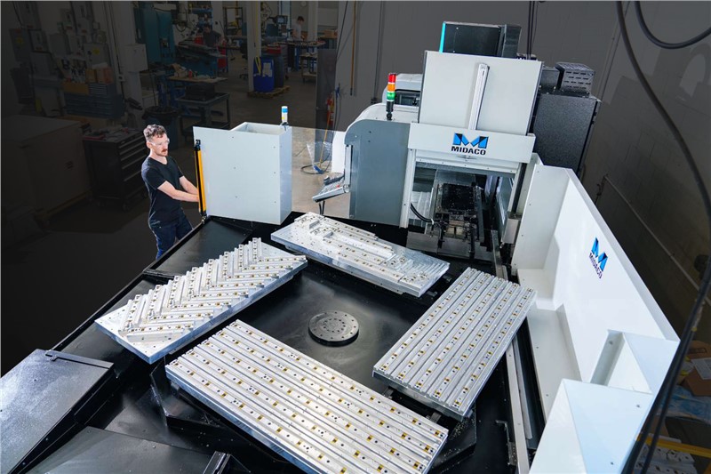 Operator running Midaco Automatic 4-Pallet Changer on Hurco VMC