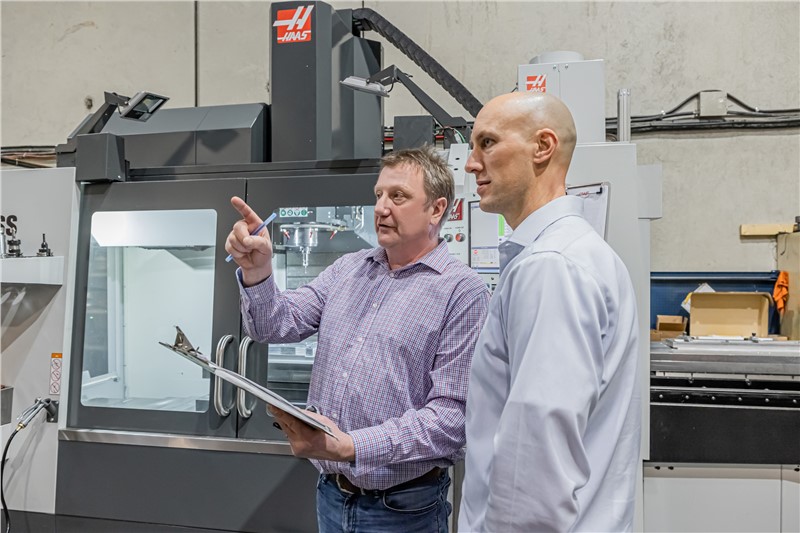 Duo CNC General Manager Helmut Hartmann and owner Terrance Visser discuss production on Duo CNC’s shop floor.  - image credit MMS
