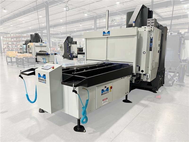 Midaco Automatic Pallet Changer on a VMC in Machine shop with 2 other Midaco Pallet Changers on VMCs in the background