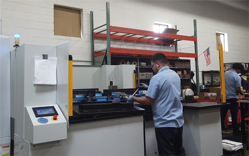 Operator changing parts on Midaco Automatic 4-Pallet Pool in machine shop 